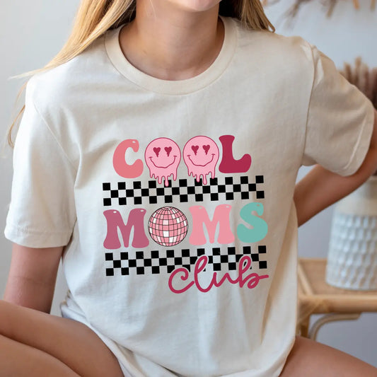 DTF Transfers ready to press – Cool Moms Club retro smiley face design with checkerboard and disco ball accents on cream t-shirt.