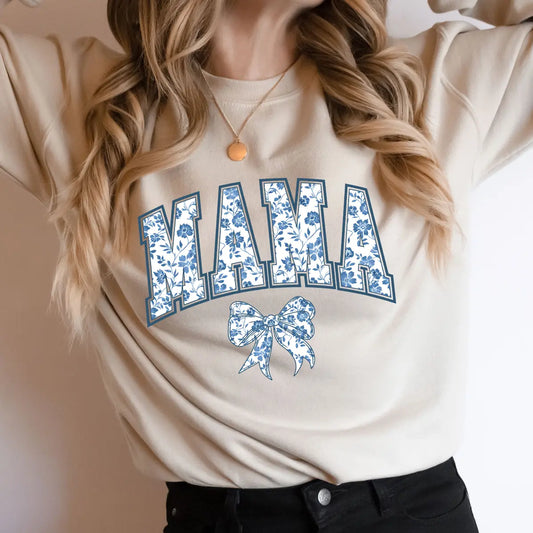 DTF Transfers ready to press – Blue Floral Bow Mama design featuring floral-filled collegiate letters and matching bow on beige t-shirt.