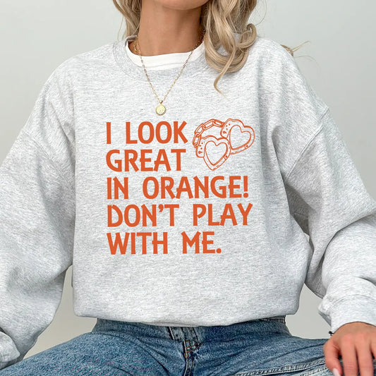 DTF Transfers ready to press – bold orange “I Look Great in Orange! Don’t Play with Me” design with heart-shaped handcuffs for t-shirts and sweatshirts.