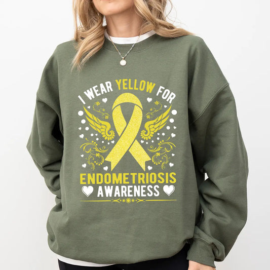DTF Transfers ready to press – Yellow awareness ribbon with wings and hearts, featuring “I Wear Yellow for Endometriosis Awareness” text on green sweatshirt.