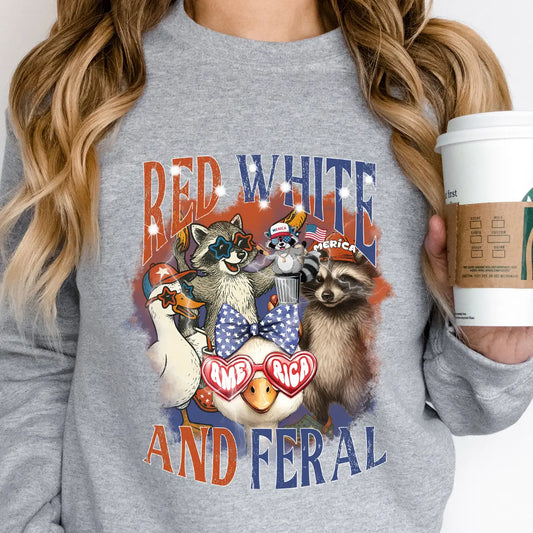 Gray sweatshirt with “Red White and Feral” DTF transfer featuring patriotic raccoons, ducks, and opossum in red, white, and blue celebration gear.