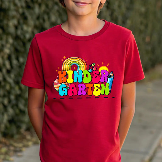 Red T-shirt with bright rainbow-themed “KINDERGARTEN” DTF transfer design for kids.