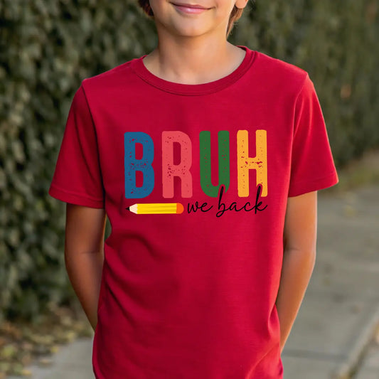 Red T-shirt with “BRUH We Back” DTF transfer design featuring large colorful block letters, a pencil graphic, and handwritten text.