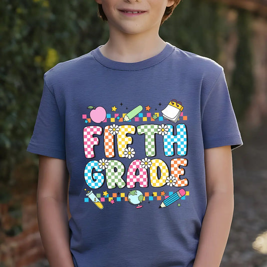 Navy-blue T-shirt with “Fifth Grade” DTF transfer design featuring colorful checkered letters, daisies, and fun school icons like globe, apple, and pencil.