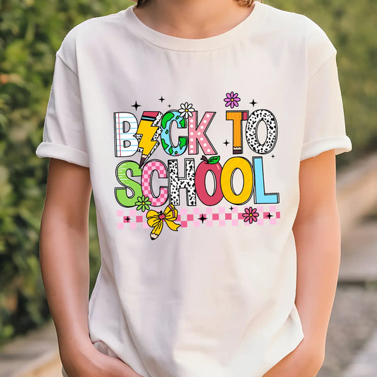 White T-shirt with “Back to School” DTF transfer design in large colorful patterned letters with florals, bow, lightning bolt, and pink checker border.