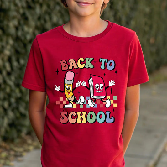 Red T-shirt with “Back to School” DTF transfer design featuring colorful cartoon pencil and book characters with multicolored block text.