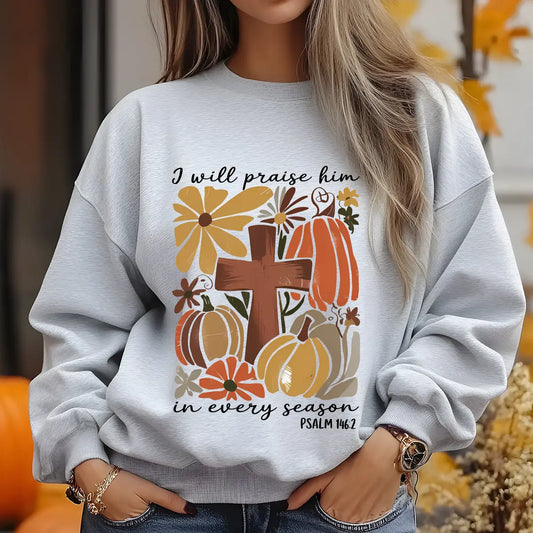 Gray sweatshirt with “I Will Praise Him in Every Season” DTF transfer design featuring rustic cross, autumn pumpkins, florals, and Psalm 146:2.
