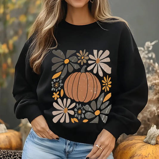 Black sweatshirt with retro-style DTF transfer design of an orange pumpkin surrounded by warm-toned autumn flowers.