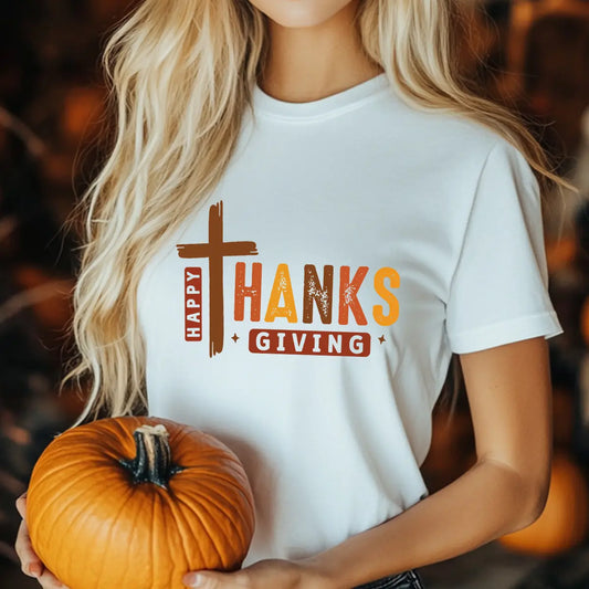 White t-shirt with "Happy Thanksgiving" DTF transfer featuring rustic cross design in warm fall colors—perfect for faith-inspired seasonal apparel.