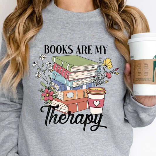 Gray sweatshirt with “Books Are My Therapy” DTF transfer design featuring stacked books, flowers, and coffee cup—ideal for cozy book lovers.