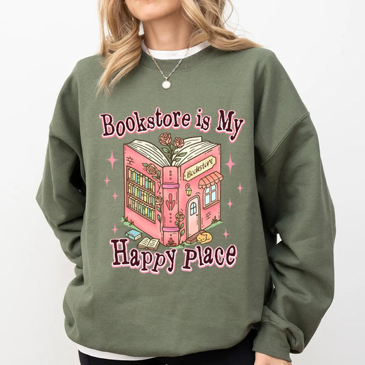 Military green sweatshirt with pink “Bookstore is My Happy Place” DTF transfer design featuring a cute illustrated bookstore.