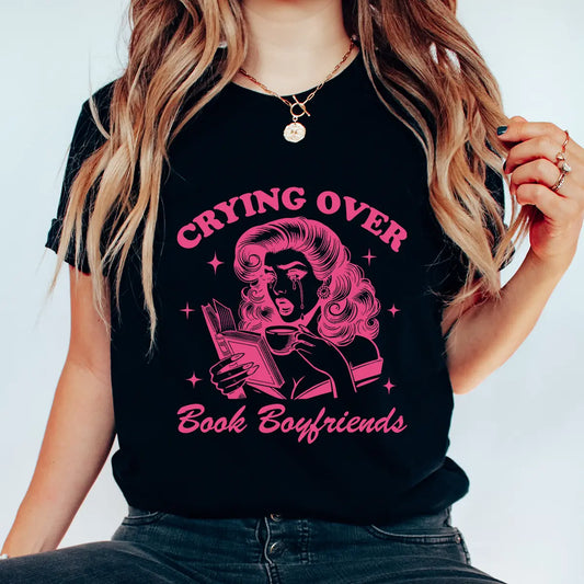 Black t-shirt with pink retro design “Crying Over Book Boyfriends” DTF transfer featuring a dramatic woman reading.