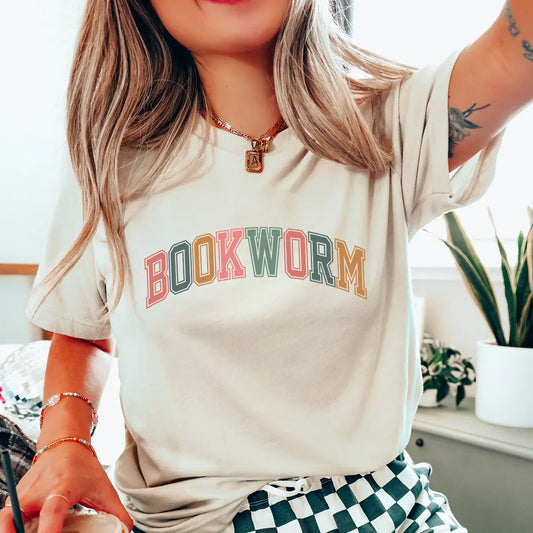Soft cream t-shirt with colorful "Bookworm" varsity-style DTF transfer design, perfect for readers and book-themed custom apparel.