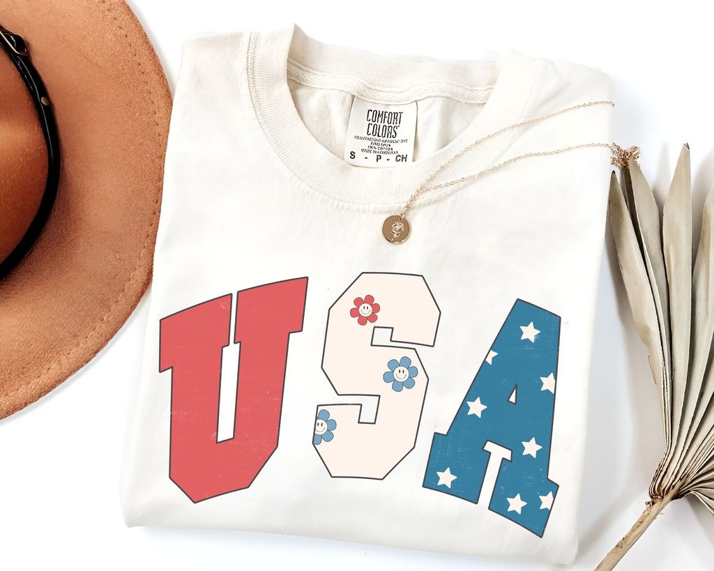 "USA Patriotic Letters" DTF transfer featuring red, white with flowers, and blue with stars for 4th of July apparel.