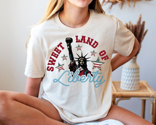 "Sweet Land of Liberty" 4th of July DTF Transfer featuring the Statue of Liberty, stars, and patriotic text design for custom festive apparel.