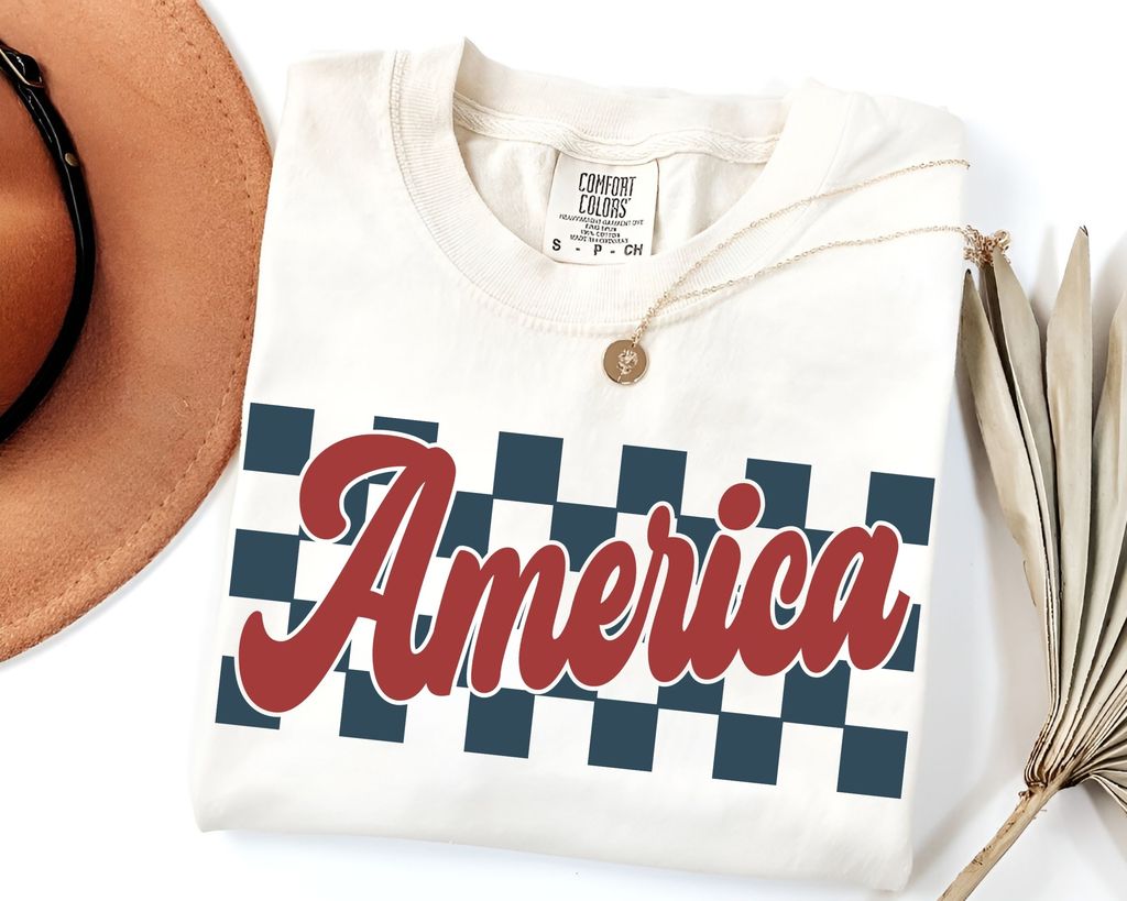 "America Checkerboard" 4th of July DTF Transfer featuring bold retro script over a navy and white checkered background.