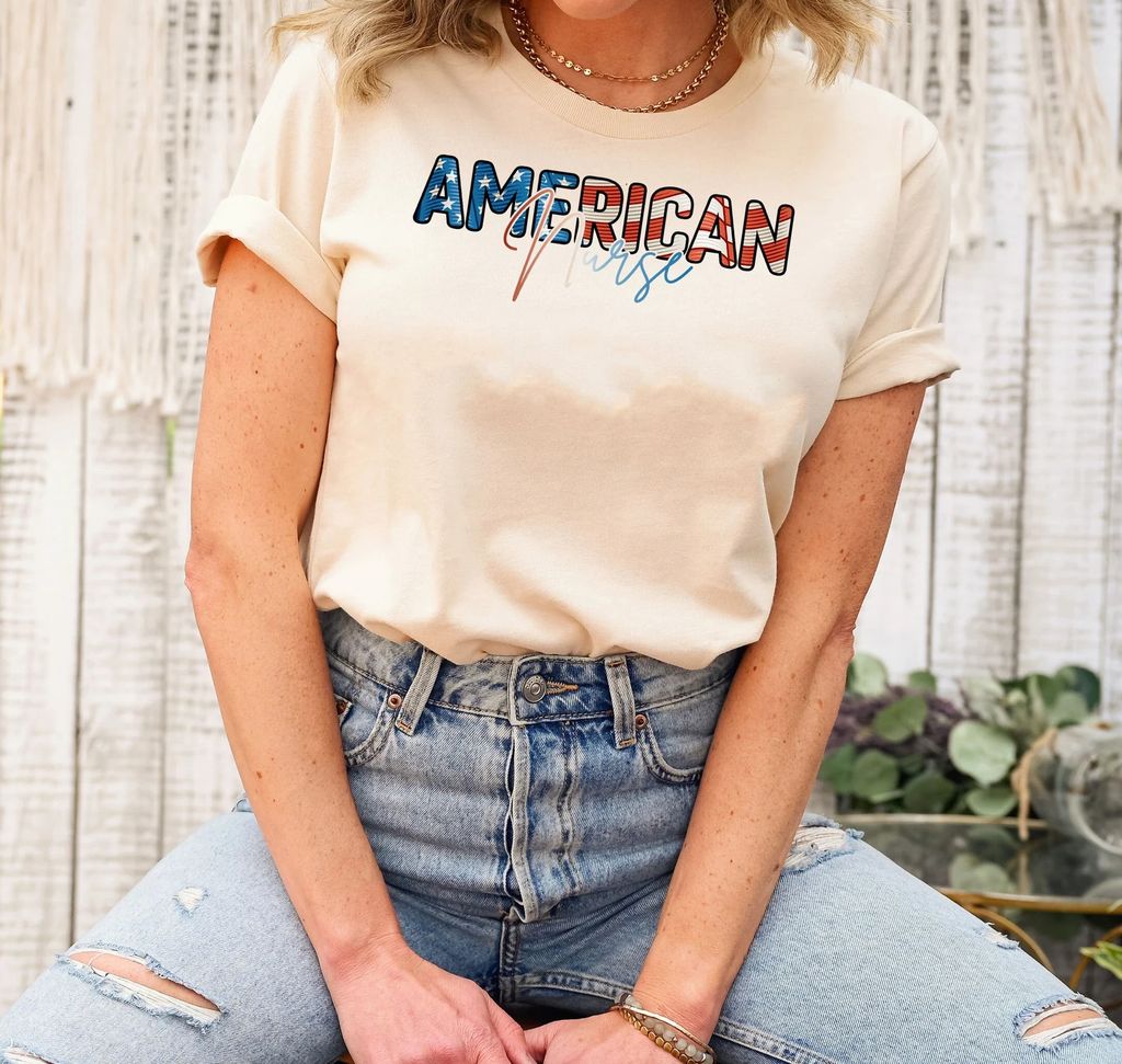 "American Nurse" 4th of July Ready-to-Press DTF Transfer printed on a neutral-colored t-shirt with patriotic lettering.