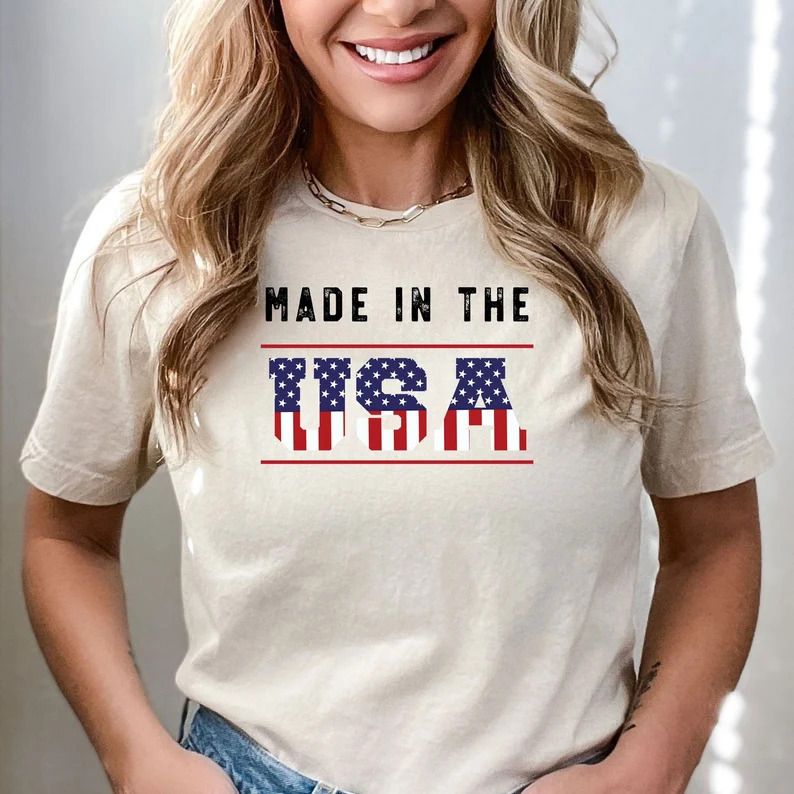 "Made in the USA" 4th of July Ready-to-Press DTF Transfer printed on a neutral-colored t-shirt with patriotic lettering.