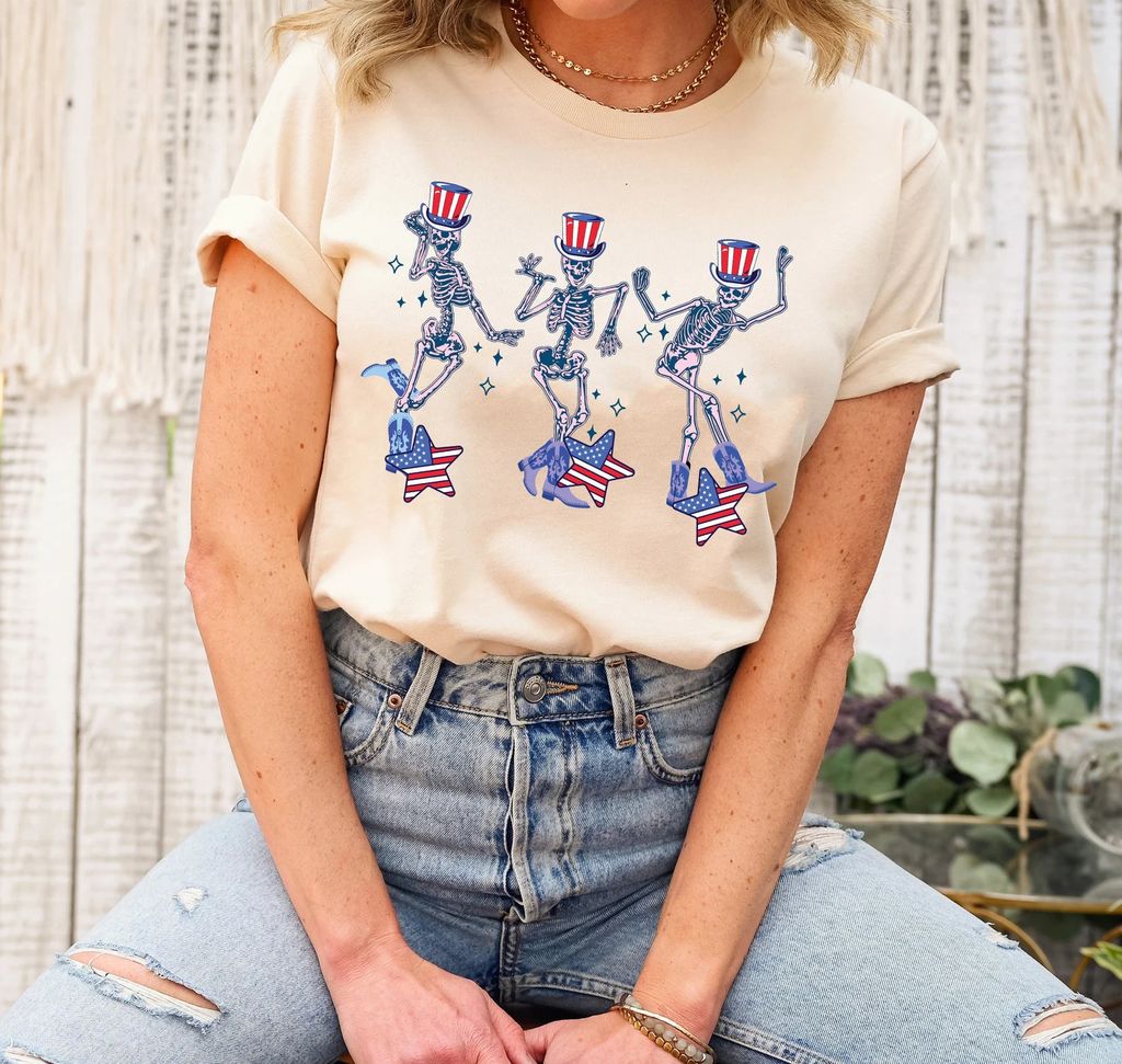 Dancing skeletons wearing Uncle Sam hats with stars and stripes—4th of July Ready-to-Press DTF Transfer on a neutral t-shirt.