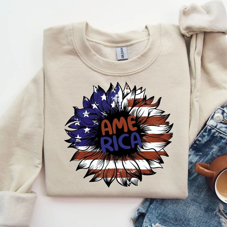 Beige sweatshirt featuring a Patriotic Sunflower America design with red, white, and blue stars and stripes, perfect for 4th of July DTF transfers.