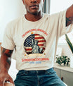 Person wearing a t-shirt celebrating America's Semiquincentennial with an American flag and Statue of Liberty graphic.