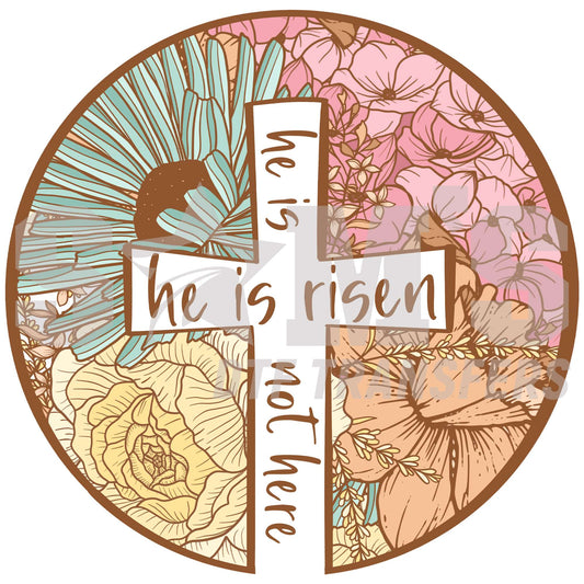 Stained glass style design featuring a cross with the words 'He is risen, not there' surrounded by intricate floral patterns in a circular frame.