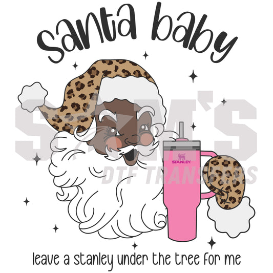 Santa with a leopard print hat holding a Stanley mug and a chocolate chip cookie and "leave a stanley under the tree for me" text, a premium custom DTF design by Sam's DTF Transfers.