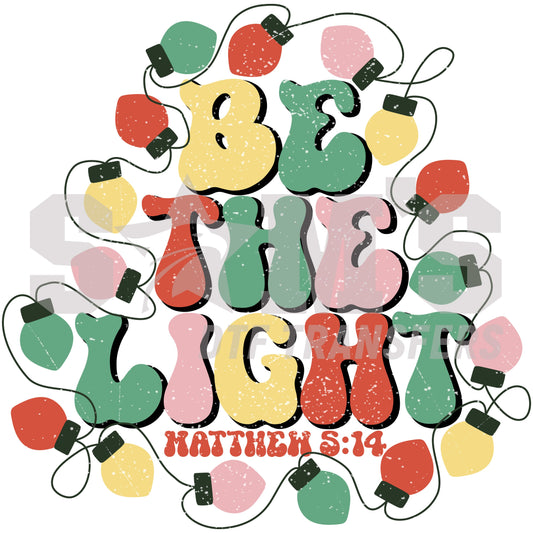 Colorful Christmas lights spelling out 'Be The Light' with the reference to Matthew 5:14, symbolizing the spirit of the season, a premium custom DTF design by Sam's DTF Transfers