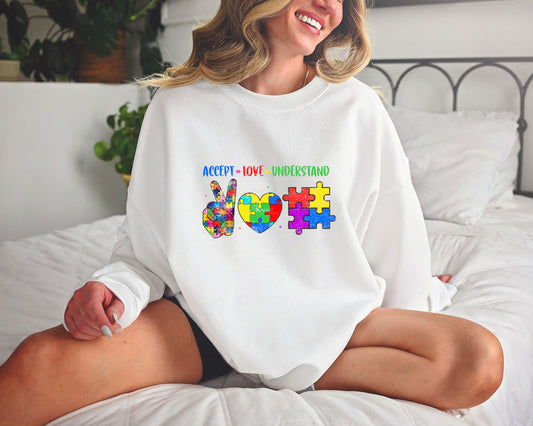 Autism awareness DTF transfer design with "Accept, Love, Understand" text and colorful puzzle shapes.