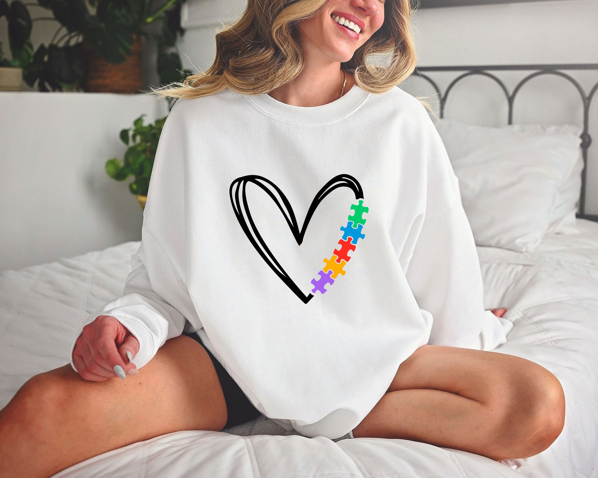 Autism awareness DTF transfer design with a minimalist black heart and colorful puzzle pieces.