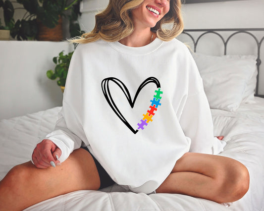 Autism awareness DTF transfer design with a minimalist black heart and colorful puzzle pieces.