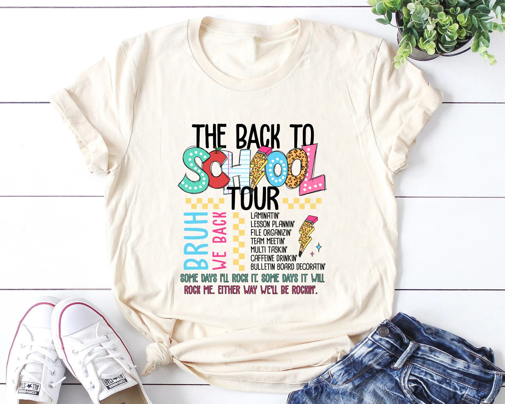 "The Back to School Tour" DTF transfer design on a white t-shirt featuring colorful letters, lightning bolts, and humorous school-related text for back-to-school apparel.