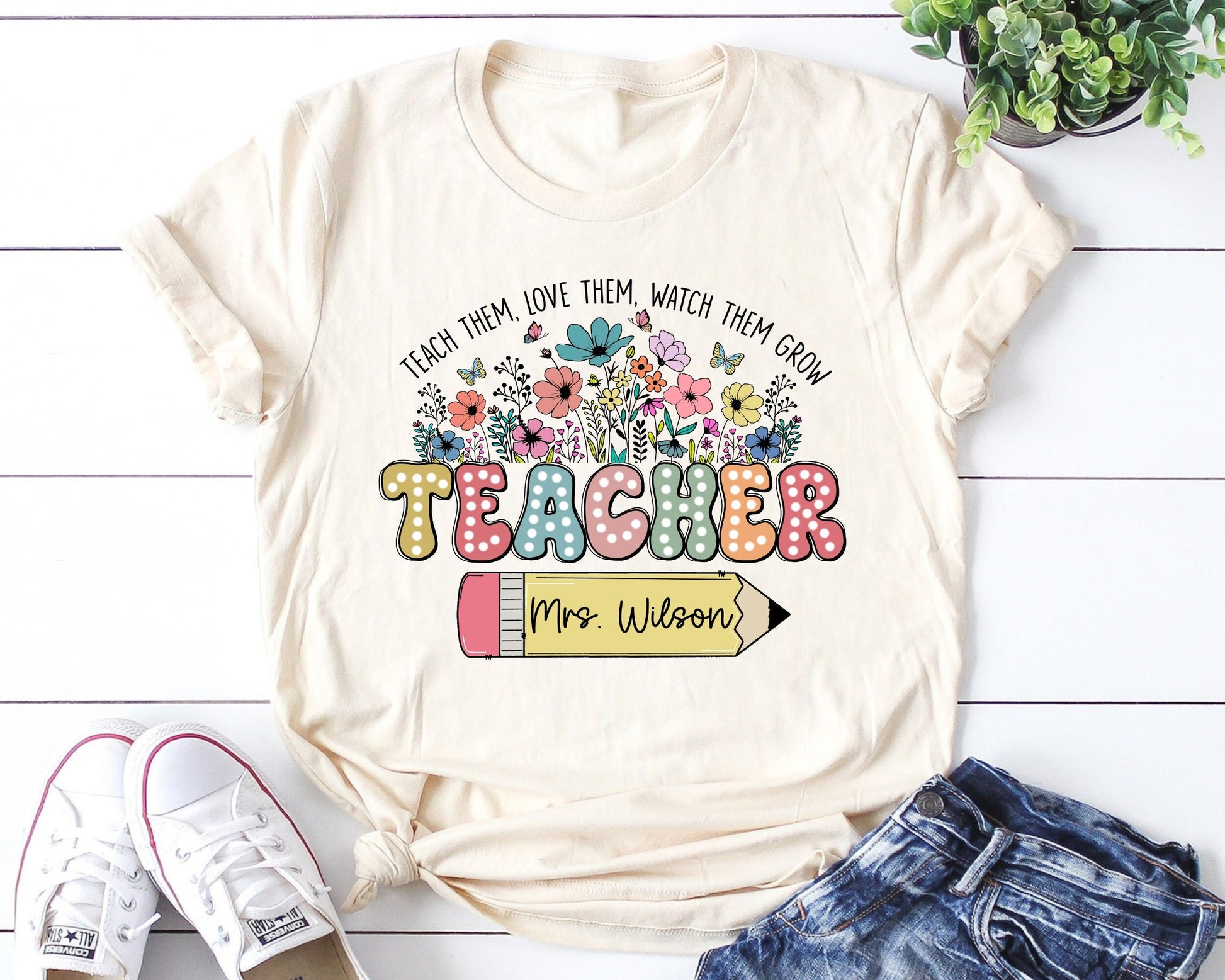 Teacher-themed DTF transfer featuring floral designs, colorful typography, and a customizable pencil for personalizing teacher names. Perfect for heat-pressed t-shirts.