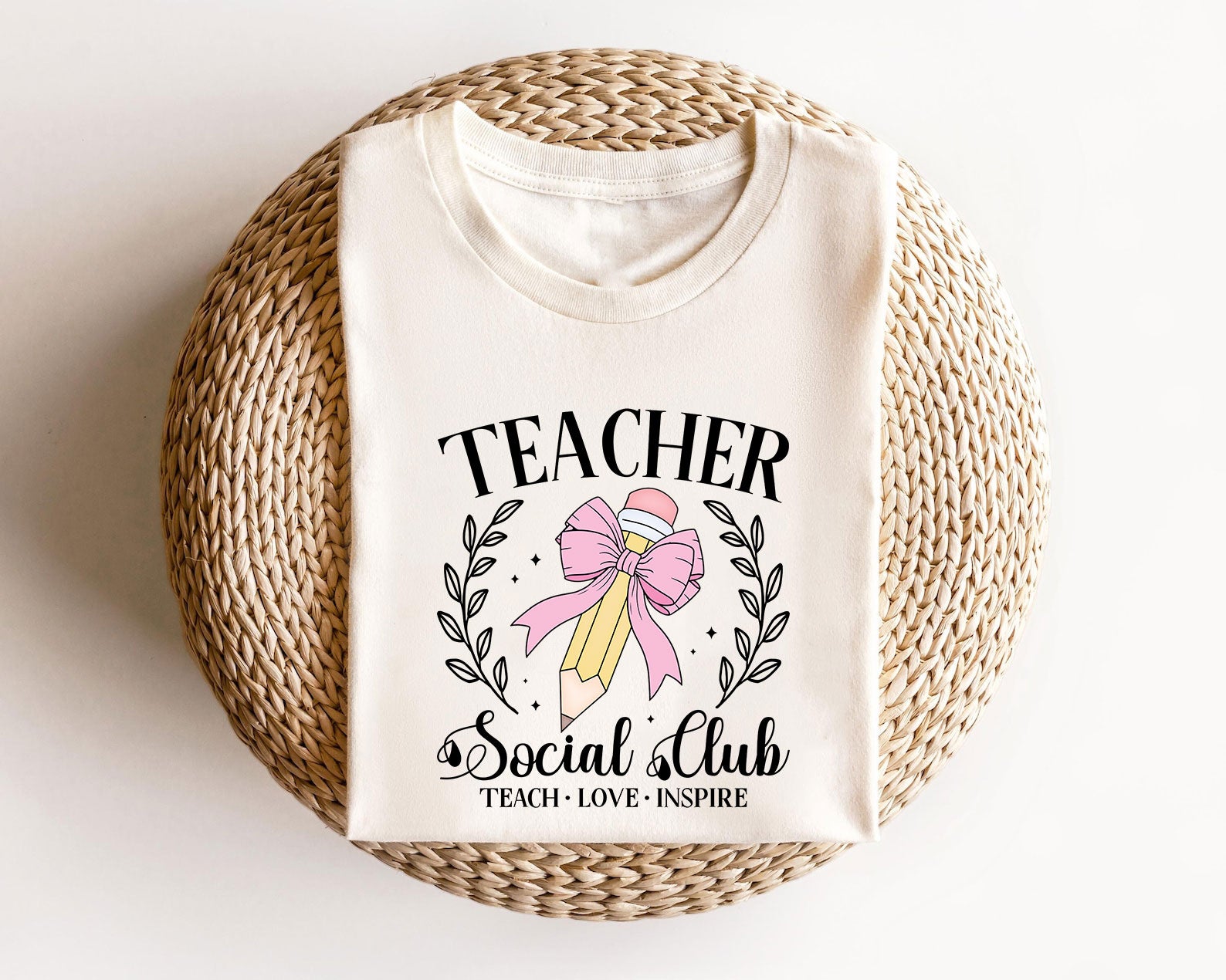 Beige sweatshirt with a Teacher Social Club DTF transfer featuring a pencil with a pink bow.