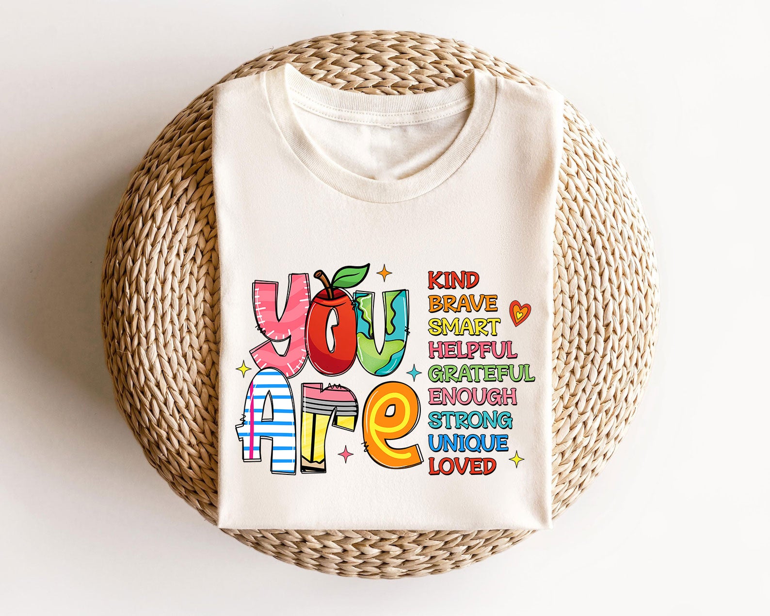 Beige sweatshirt with "You Are Kind Brave Smart" teacher-inspired colorful typography design.