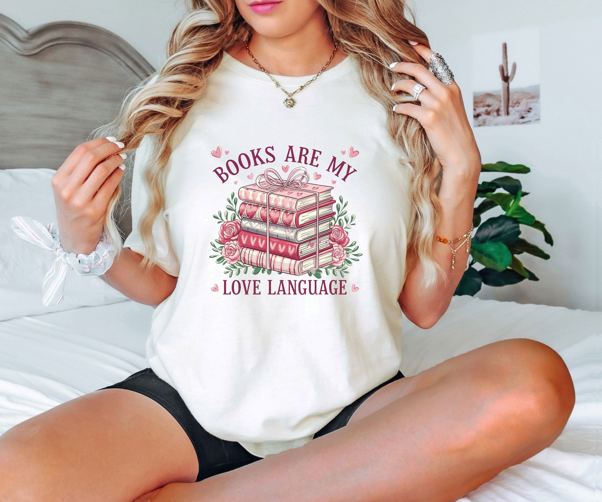 "Books Are My Love Language" DTF transfer design on a white t-shirt featuring a stack of books with heart accents surrounded by roses and romantic text.