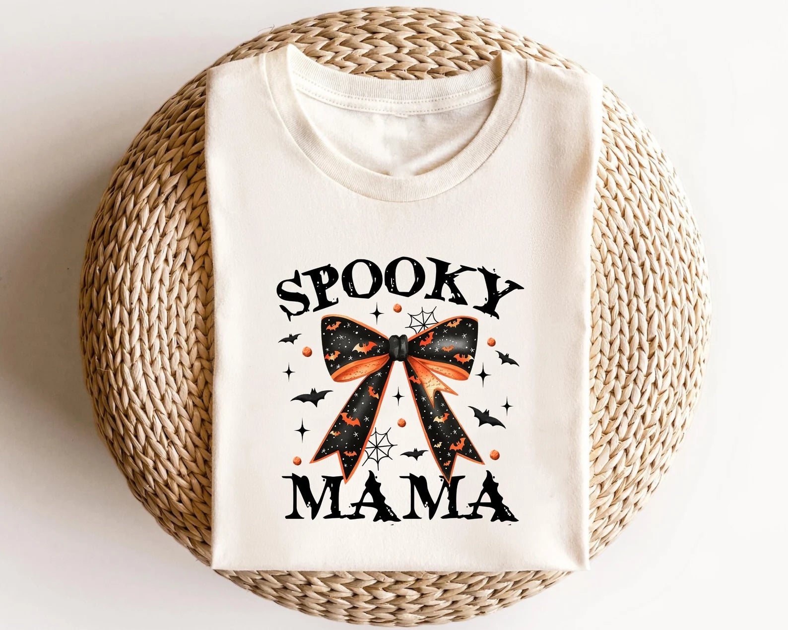 Spooky Mama Halloween DTF transfer with orange and black bow on a cream t-shirt