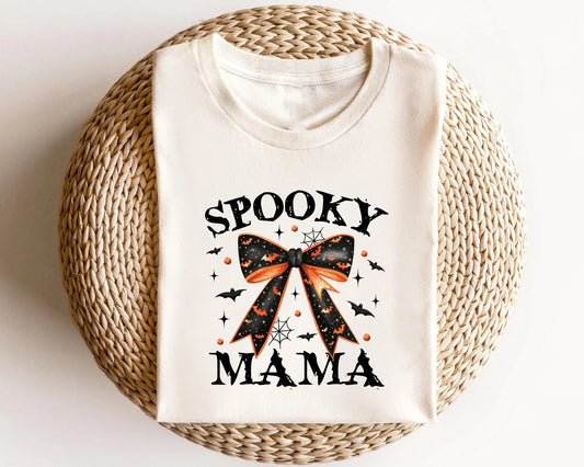 Spooky Mama Halloween DTF transfer with orange and black bow on a cream t-shirt