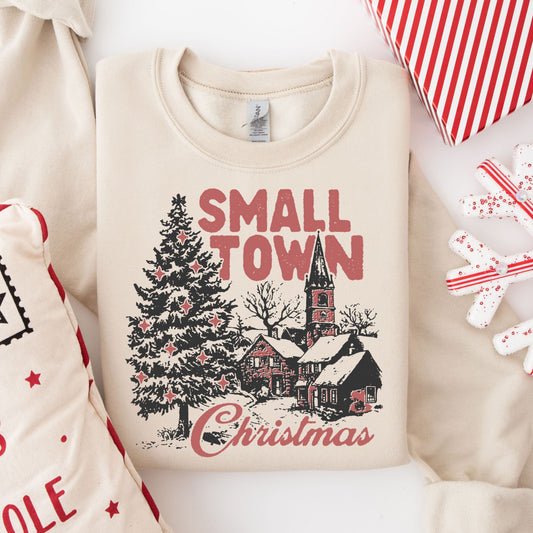  Small town Christmas sweatshirt design featuring a snowy landscape and quaint church, perfect for festive apparel.