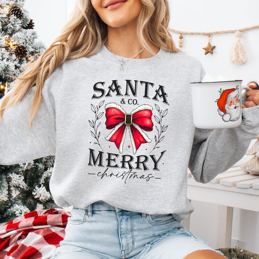 Santa & Co. Merry Christmas design with red bow and winter foliage on a sweatshirt, ideal for holiday season apparel.