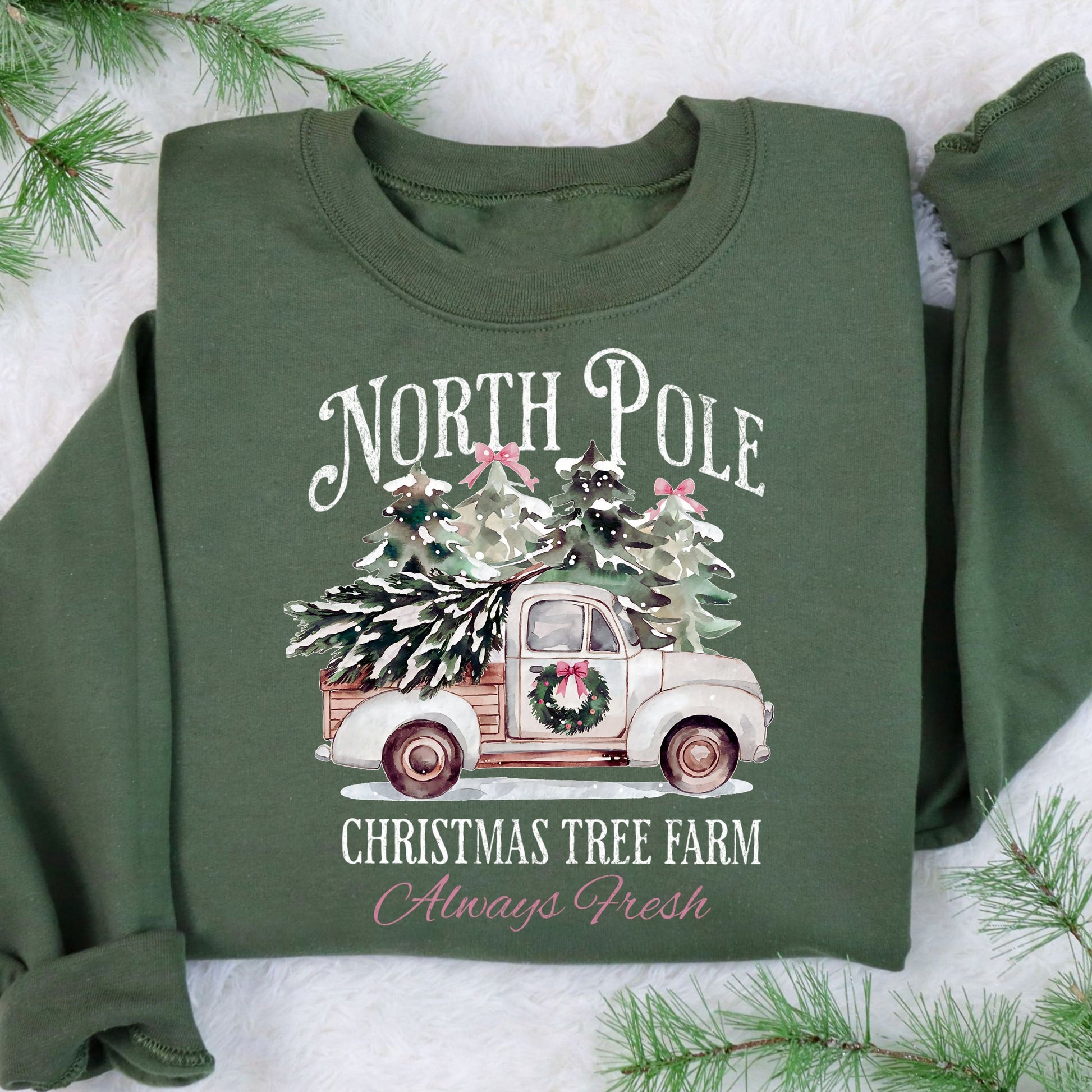 Vintage truck carrying a Christmas tree in the 'North Pole Christmas Tree Farm' design on a green sweatshirt.