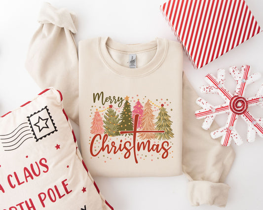 Colorful "Merry Christmas" ready-to-press DTF transfer with Christmas trees on a beige sweater, ideal for holiday DIY projects.