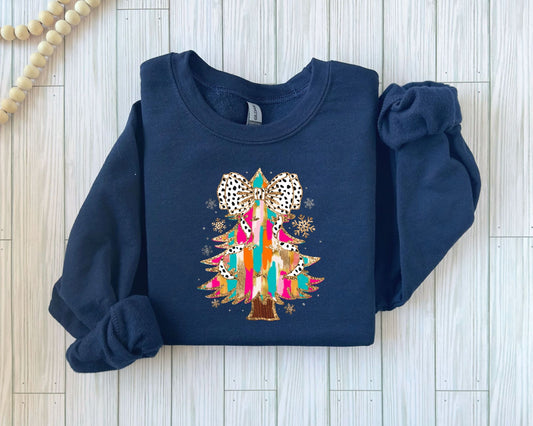 Whimsical Christmas tree with colorful decorations on a dark blue sweater, a festive ready-to-press DTF transfer for the holiday season.