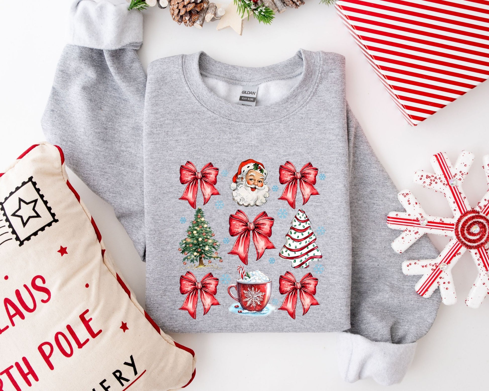 Classic Christmas-themed ready-to-press DTF transfer with Santa Claus, Christmas trees, and decorative bows on a grey sweater, perfect for holiday crafting.