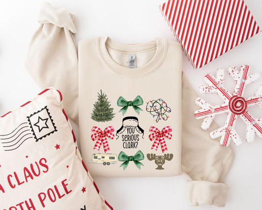 Humorous Christmas-themed ready-to-press DTF transfer featuring a Christmas tree, quirky decorations, and the quote "You Serious Clark?" on a beige sweater.