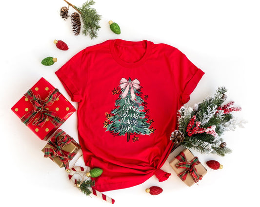 Elegant Christmas tree DTF transfer with the phrase "Oh Come Let Us Adore Him" on a red t-shirt, surrounded by holiday decor.