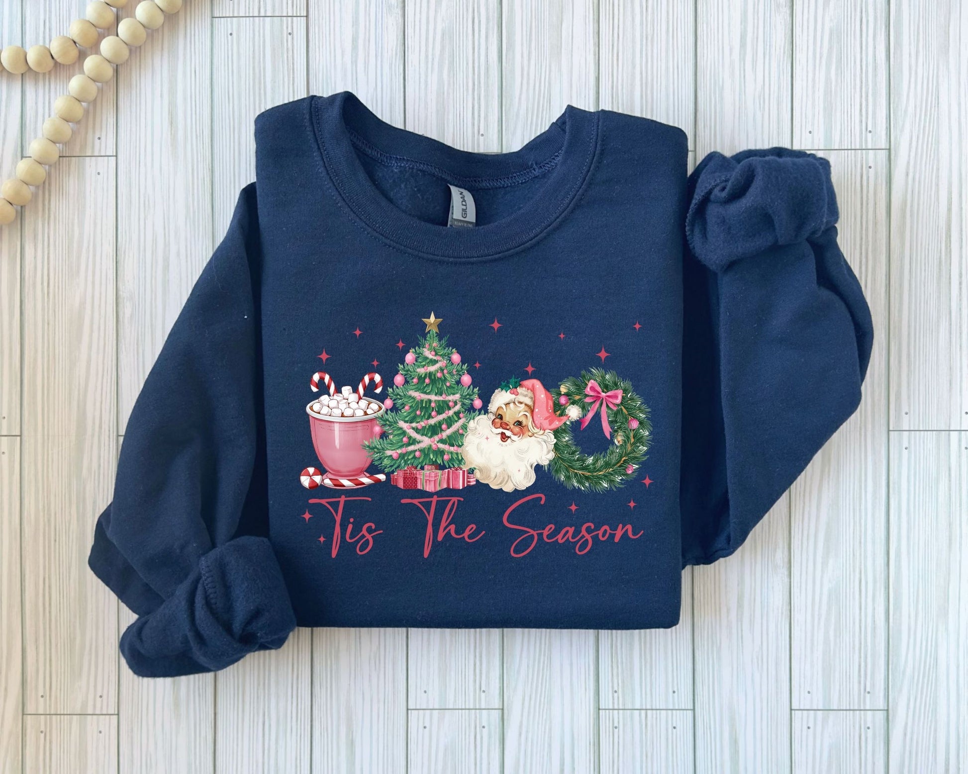 Santa enjoying a mug of hot cocoa on a dark navy Christmas sweatshirt design.