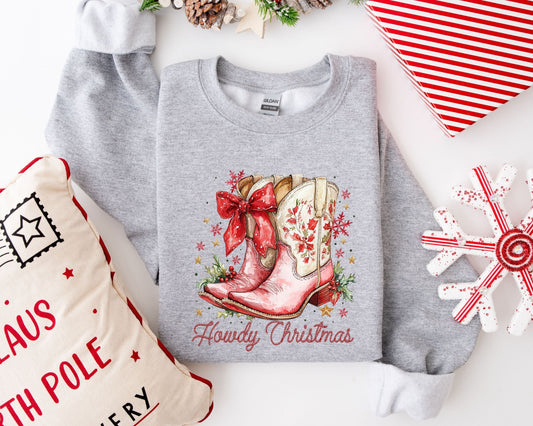 Cowboy boots with a red bow on a gray Christmas sweatshirt design.