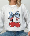 Gray sweatshirt mockup featuring two cherries tied with an American flag bow – Memorial & Patriotic DTF Transfers ready-to-press design