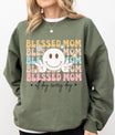 DTF Transfers ready to press – Blessed Mom pastel design with peace sign smiley and floral details on a green sweatshirt.